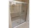 Bathroom shower with glass doors and tile surround at 16618 Kingletside Ct, Lithia, FL 33547