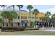 Shops and restaurants in a town center featuring palm trees and a fountain at 16618 Kingletside Ct, Lithia, FL 33547