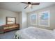 Bright bedroom featuring a wood dresser and windows at 1897 Trailside Dr, Palm Harbor, FL 34683
