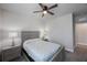 This bedroom features a ceiling fan and light gray carpet flooring at 1897 Trailside Dr, Palm Harbor, FL 34683