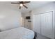 This bedroom features a ceiling fan and light gray carpet flooring at 1897 Trailside Dr, Palm Harbor, FL 34683