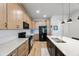 Modern kitchen featuring stainless steel appliances, a spacious island, and pendant lights at 1897 Trailside Dr, Palm Harbor, FL 34683