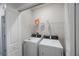 A well-organized laundry room featuring a washer and dryer at 1897 Trailside Dr, Palm Harbor, FL 34683