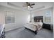 This main bedroom features a ceiling fan, ensuite bathroom, and a bench at 1897 Trailside Dr, Palm Harbor, FL 34683