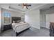 This main bedroom features a ceiling fan and light gray carpet flooring at 1897 Trailside Dr, Palm Harbor, FL 34683
