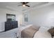 This main bedroom features an ensuite bathroom, ceiling fan, and closet at 1897 Trailside Dr, Palm Harbor, FL 34683