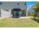 Back patio with outdoor seating and green lawn at 1897 Trailside Dr, Palm Harbor, FL 34683