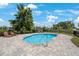 Community pool with lounge chairs surrounded by a fence at 1897 Trailside Dr, Palm Harbor, FL 34683
