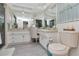 Bathroom featuring dual sinks, large vanity and a comfort height toilet at 1907 Sandpiper Dr, Clearwater, FL 33764