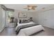 Comfortable bedroom with a queen size bed, ceiling fan, and closet at 1907 Sandpiper Dr, Clearwater, FL 33764