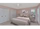 Stylish bedroom featuring a queen bed, soft lighting, and ample closet space at 1907 Sandpiper Dr, Clearwater, FL 33764