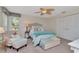 Bedroom features a plush bed, comfortable armchair, window and built in closets at 1907 Sandpiper Dr, Clearwater, FL 33764