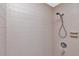 Shower stall featuring sleek neutral tiles and a modern shower head at 1907 Sandpiper Dr, Clearwater, FL 33764