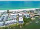 Wide angle aerial shows beachfront condos with a pool, private dock, and direct beach access at 19925 Gulf Blvd # 105, Indian Shores, FL 33785
