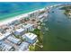A stunning aerial view of condos, a marina, and a pristine beach at 19925 Gulf Blvd # 105, Indian Shores, FL 33785