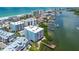 High-angle view showcases waterfront condos, beach access, boat docks, and community amenities at 19925 Gulf Blvd # 105, Indian Shores, FL 33785
