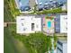 Overhead view of waterfront condos featuring a rooftop, pool, private dock, and parking area at 19925 Gulf Blvd # 105, Indian Shores, FL 33785