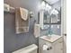Bathroom featuring gray walls, a toilet, vanity, mirror, and towel racks at 19925 Gulf Blvd # 105, Indian Shores, FL 33785