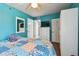Bedroom featuring a closet, dresser with television, and an ensuite bathroom at 19925 Gulf Blvd # 105, Indian Shores, FL 33785