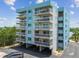 Multi-story residential building with white balconies and blue accents overlooking the water at 19925 Gulf Blvd # 105, Indian Shores, FL 33785