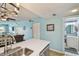 Kitchen view with modern quartz counters, opening to the living room and bathroom at 19925 Gulf Blvd # 105, Indian Shores, FL 33785
