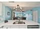 Open kitchen view showing stainless dishwasher, faucet, and sink on white quartz counter at 19925 Gulf Blvd # 105, Indian Shores, FL 33785