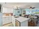 Open concept kitchen with island seating flows into the dining and living areas at 19925 Gulf Blvd # 105, Indian Shores, FL 33785