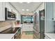 A bright kitchen with white cabinets and stainless steel appliances at 19925 Gulf Blvd # 105, Indian Shores, FL 33785