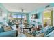 Inviting living room with sliding doors to the balcony offering water views at 19925 Gulf Blvd # 105, Indian Shores, FL 33785