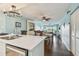 Spacious living area showcasing dining area, ceiling fan, and access to balcony at 19925 Gulf Blvd # 105, Indian Shores, FL 33785
