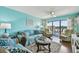 Comfortable living room featuring a ceiling fan and access to an outdoor balcony at 19925 Gulf Blvd # 105, Indian Shores, FL 33785