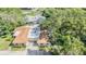 A sun-drenched view of the home and its property, including nearby streets and mature shade trees at 2150 Shelly Dr # D, Palm Harbor, FL 34684