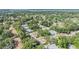 Beautiful aerial view of a neighborhood filled with lush trees and single-story homes near a tranquil lake at 2150 Shelly Dr # D, Palm Harbor, FL 34684