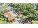 A sunny aerial view of a home with well-maintained landscaping, a driveway, and a peaceful green backyard at 2150 Shelly Dr # D, Palm Harbor, FL 34684