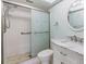 Bathroom with a marble vanity, toilet, and glass door shower at 2150 Shelly Dr # D, Palm Harbor, FL 34684