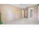 Spacious bedroom featuring neutral paint, tile floor, ceiling fan and ensuite bathroom at 2150 Shelly Dr # D, Palm Harbor, FL 34684