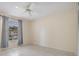 Bedroom features tile floors, ceiling fan, and one window with a blue curtain at 2150 Shelly Dr # D, Palm Harbor, FL 34684