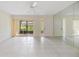 Bright living room with tiled flooring, ceiling fan, and sliding door access to the patio at 2150 Shelly Dr # D, Palm Harbor, FL 34684