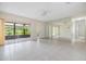 Spacious living room featuring tile floors, a mirrored wall, and lots of natural light at 2150 Shelly Dr # D, Palm Harbor, FL 34684