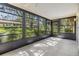Sunroom with tile flooring and floor to ceiling windows overlooking the yard at 2150 Shelly Dr # D, Palm Harbor, FL 34684