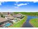 Aerial view of the property, with a private pool, overlooking a serene lake and lush greenery behind the home at 21874 Crest Meadow Dr, Land O Lakes, FL 34637