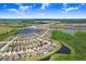Aerial view showcasing the home's location within a residential area, near a lake, and convenient roadways at 21874 Crest Meadow Dr, Land O Lakes, FL 34637