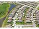 Aerial perspective of a neighborhood with houses backing onto a pond, showcasing the community layout and landscaping at 21874 Crest Meadow Dr, Land O Lakes, FL 34637