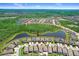 Wide aerial shot displays the house's location within a community surrounded by bodies of water and nature preserves at 21874 Crest Meadow Dr, Land O Lakes, FL 34637