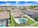 A backyard with a pool, hot tub, palm tree, and patio with a white picket fence surrounding the yard at 21874 Crest Meadow Dr, Land O Lakes, FL 34637