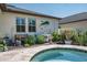 Backyard featuring a pristine pool, jacuzzi, garden, and fish wall art at 21874 Crest Meadow Dr, Land O Lakes, FL 34637