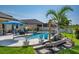 Backyard featuring a pristine pool, landscaped rocks, and backyard seating at 21874 Crest Meadow Dr, Land O Lakes, FL 34637
