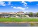 A backyard view featuring a lush green lawn, white picket fence, and view of the back of neighboring houses at 21874 Crest Meadow Dr, Land O Lakes, FL 34637