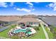 Aerial view of a backyard oasis featuring a pool, spa, rock waterfall, and lush landscaping at 21874 Crest Meadow Dr, Land O Lakes, FL 34637