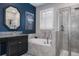 A luxurious bathroom with a soaking tub, a glass-enclosed shower, and dual sinks at 21874 Crest Meadow Dr, Land O Lakes, FL 34637